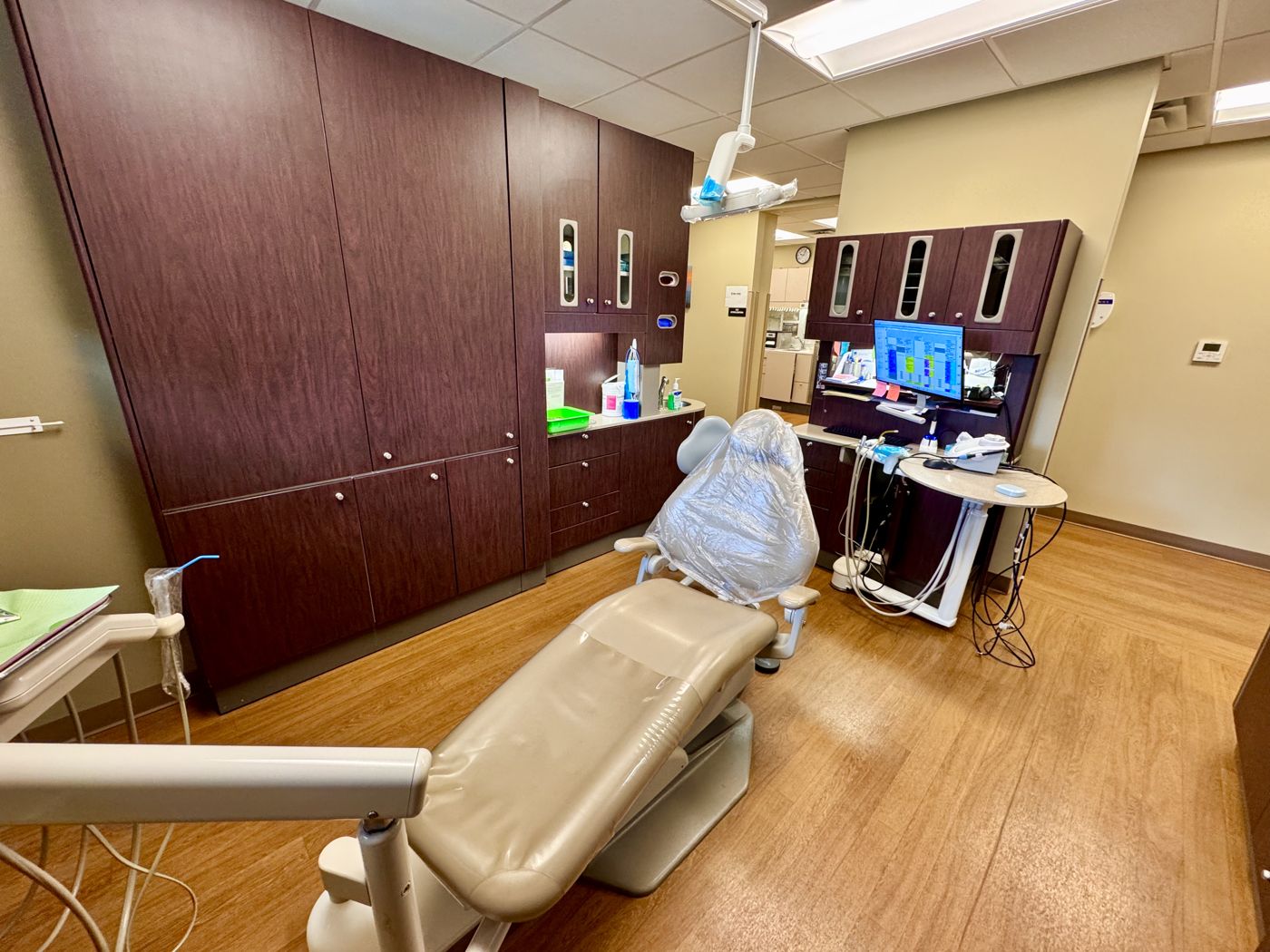 A modern dental operatory with a treatment chair and equipment